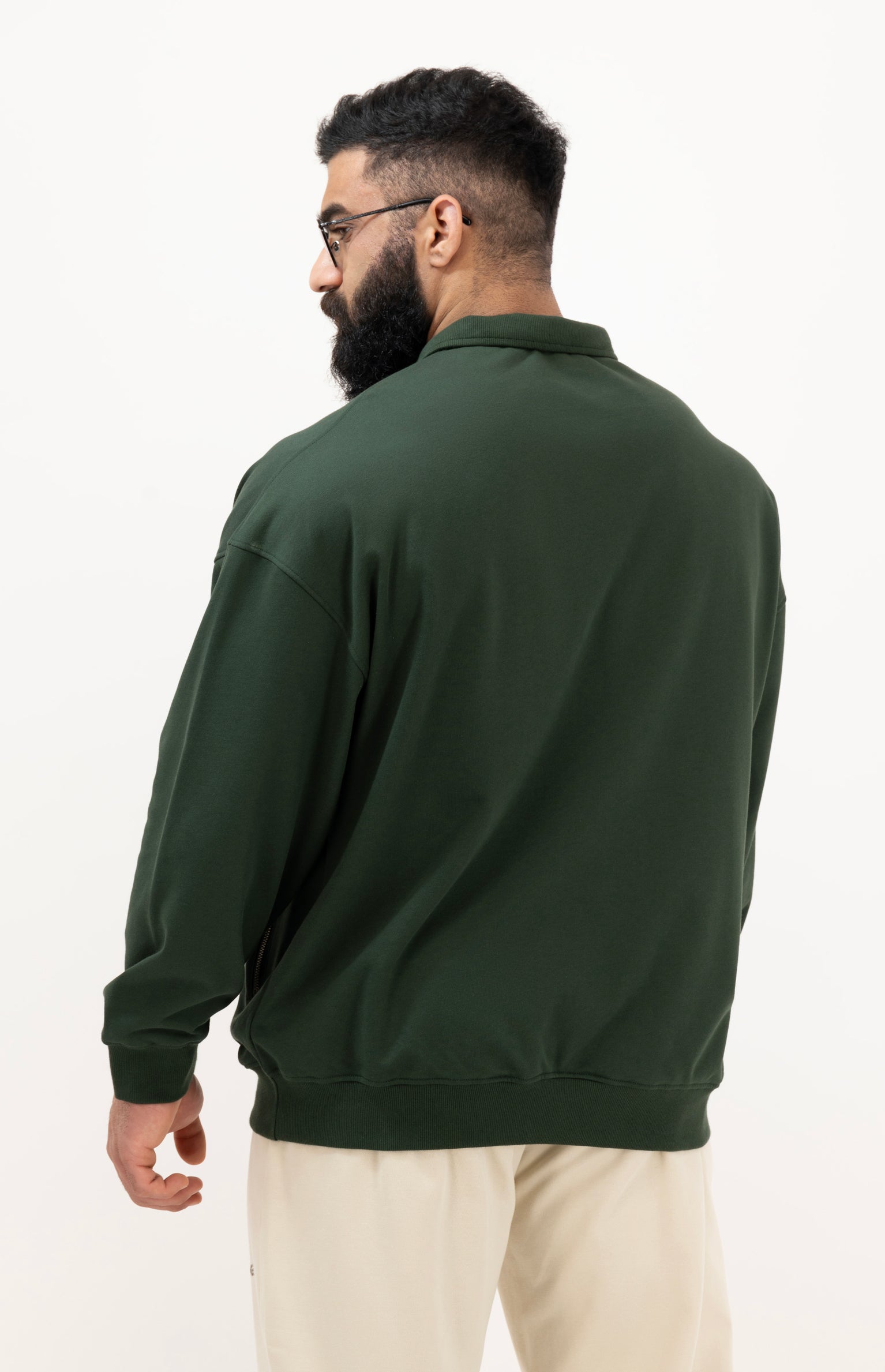Man wearing a green jacket on a white background