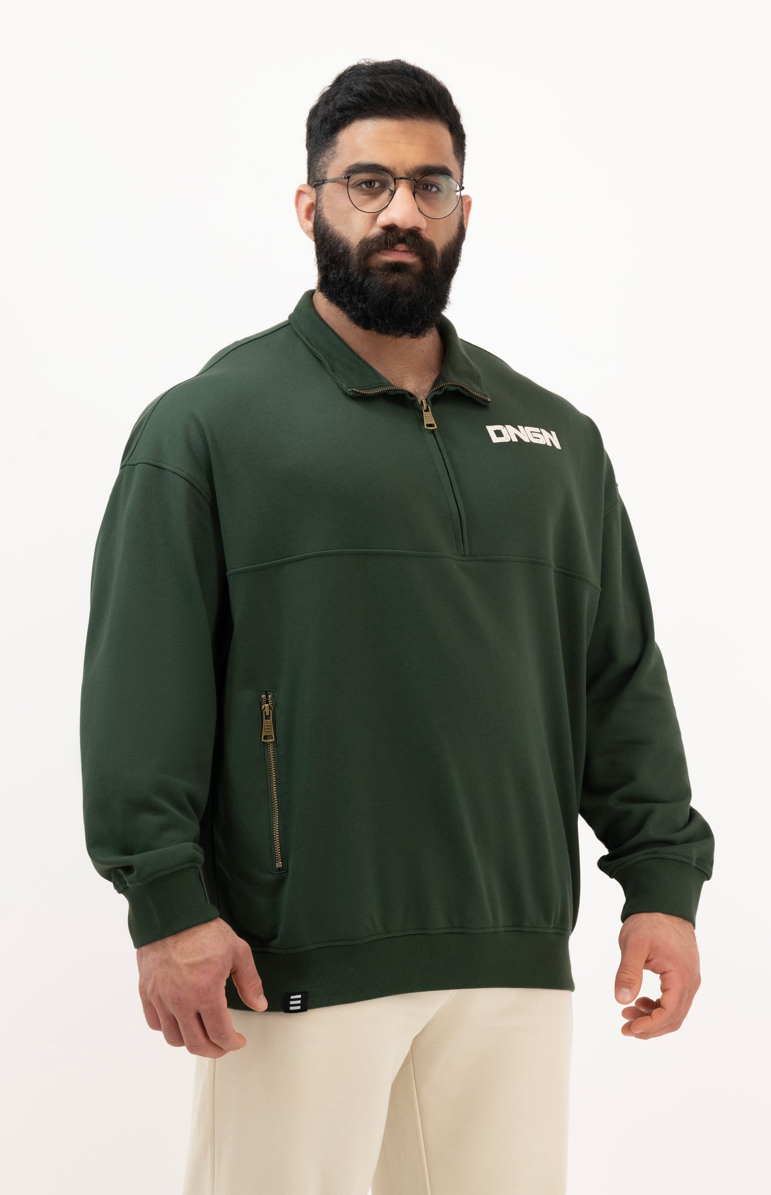 Man wearing a green sweatshirt with a brand logo on a white background